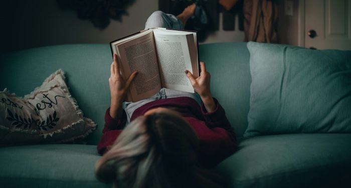 woman reading on couch 700 x 375.jpeg.optimal